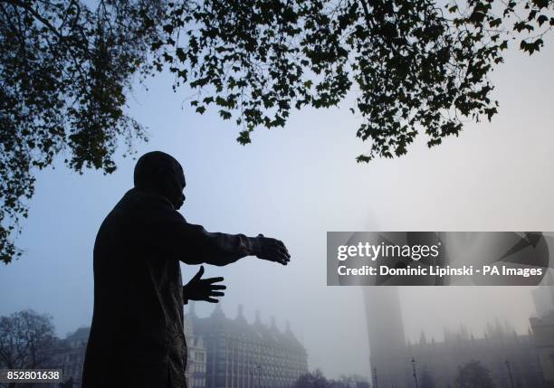 The statue of Nelson Mandela in thick fog from Westminster Bridge, in Westminster, central London.