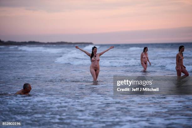 Naked bathers enter the water as they take part in the North East Skinny Dip at Druridge bay on September 25, 2017 in Druridge, England. The popular...