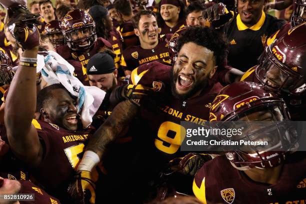 Ochuko Duke and Jay Jay Wilson of the Arizona State Sun Devils celebrate with teammates after defeating the Oregon Ducks in the college football game...