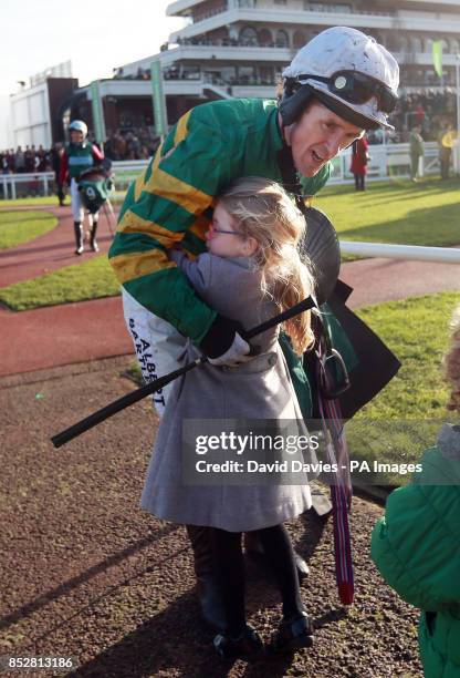 Tony McCoy is congratulated by his daughter Eve after his victory on Eastlake in the Jenny Mould Memorial Handicap Chase during day two of the 2013...
