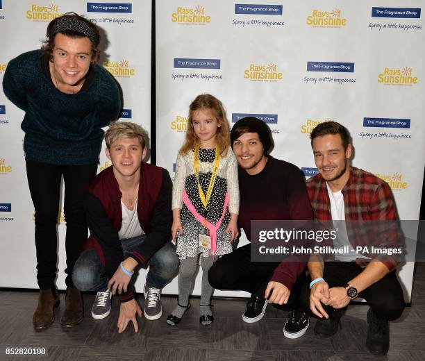 Four members of the boy band One Direction Harry Styles, Niall Horan, Louis Tomlinson and Liam Payne with fan Roxanne Watts from Hull in Yorkshire,...