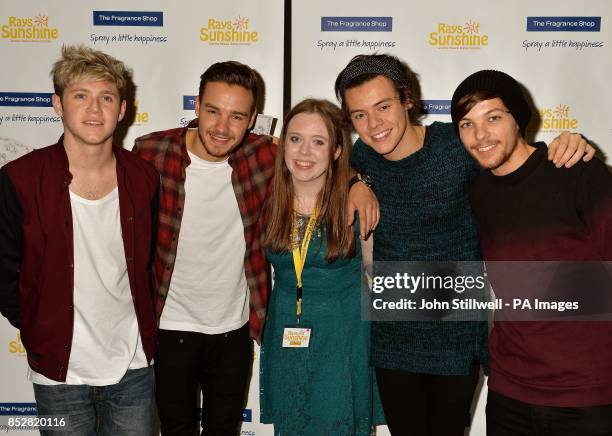 Four members of the boy band One Direction Niall Horan, Liam Payne, Harry Styles and Louis Tomlinson with fan Elena Byrne from Strabane in Northern...