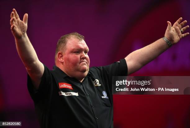 John Henderson celebrates winning his match against Dave Chisnall during day three of The Ladbrokes World Darts Championship at Alexandra Palace,...