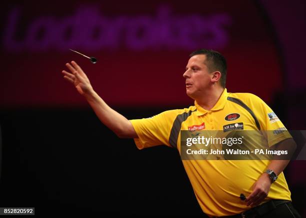 Dave Chisnall in action during his match against John Henderson during day three of The Ladbrokes World Darts Championship at Alexandra Palace,...