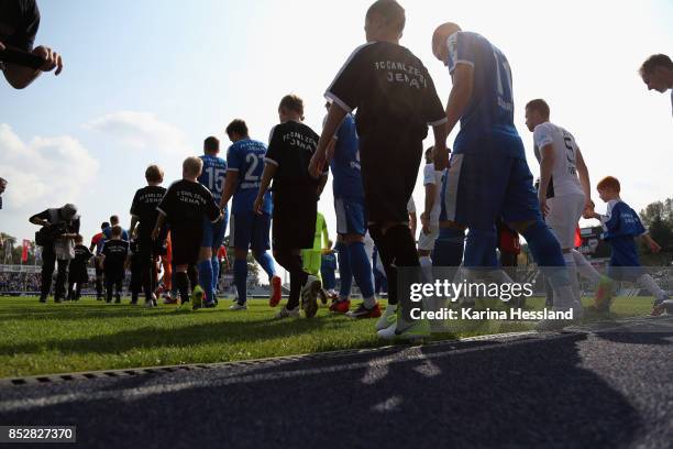 Both teams come into the stadium during the 3.Liga match between FC Carl Zeiss Jena and SC Preussen Muenster at Ernst-Abbe Sportfeld on September 23,...