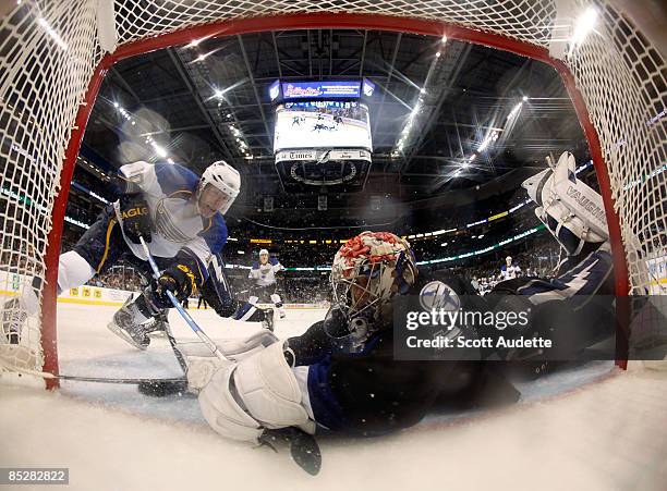 Goaltender Karri Ramo of the Tampa Bay Lightning dives across the goal to make a save against Andy McDonald of the St. Louis Blues at the St. Pete...