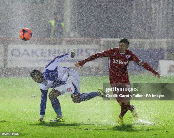 Bristol Rovers's Ellis Harrison is challenged by Crawley Town's Dannie Bulman during the FA Cup Second round replay match at Broadfield Stadium,...