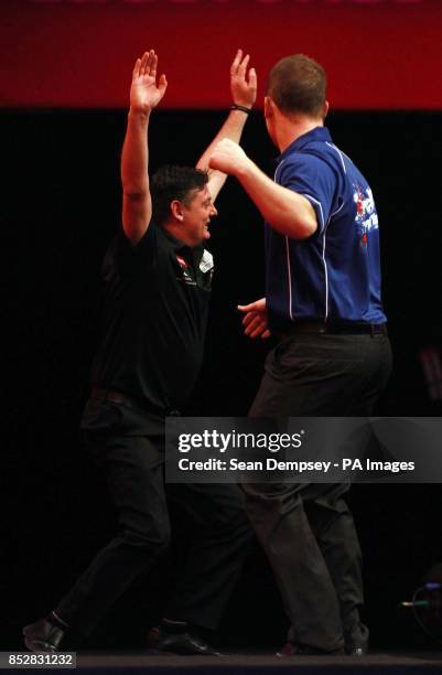 Justin Pipe celebrates winning the match against Arron Monk during day six of The Ladbrokes World Darts Championship at Alexandra Palace, London.