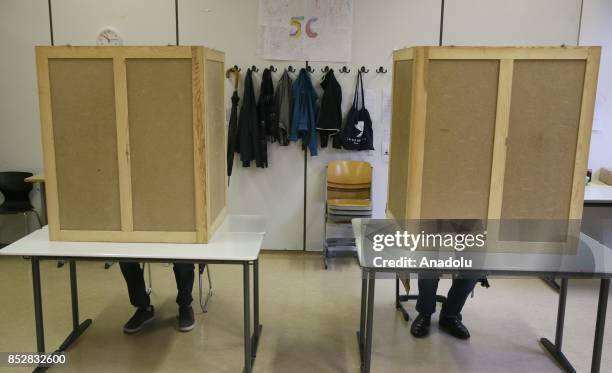 German voters cast their ballots in German federal elections at a polling station in Berlin, Germany on September 24, 2017. 61.5 million people...