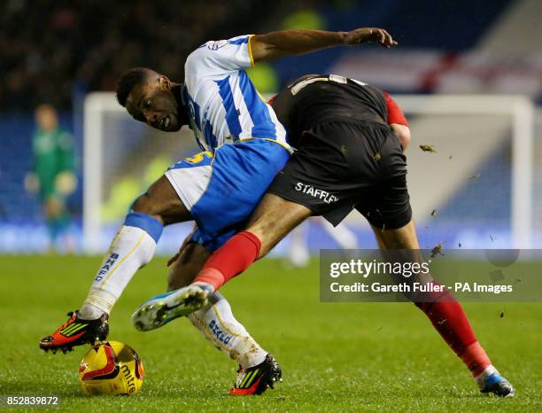 Brighton's Kazenga LuaLua is challenged by Huddersfield's Tommy Smith during the Sky Bet Championship match at the AMEX Stadium, Brighton.