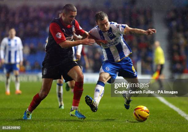 Huddersfield's Tommy Smith challenges Brighton's Ashley Barnes during the Sky Bet Championship match at the AMEX Stadium, Brighton.