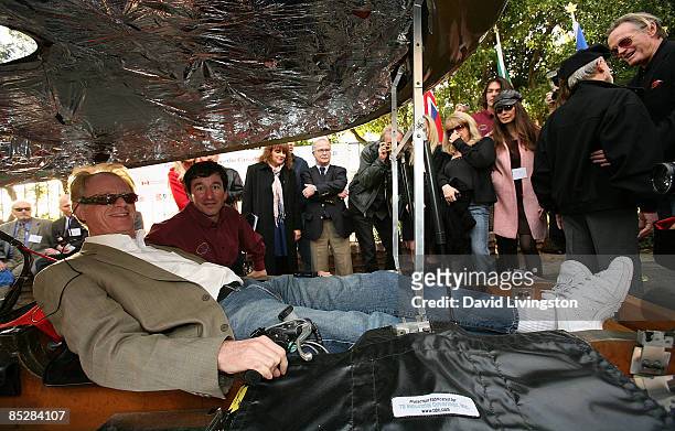 Actor Ed Begely Jr. Poses in the Solar XOF1 with the vehicle's designer Marcelo da Luz as actor Peter Fonda watches during the car's unveiling at a...