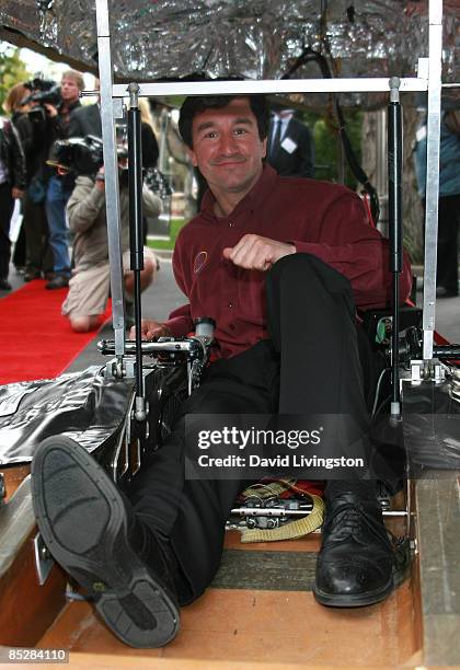 Car designer Marcelo da Luz poses in his Solar XOF1 at its unveiling during a reception at the official residence of the Consul General of Canada on...