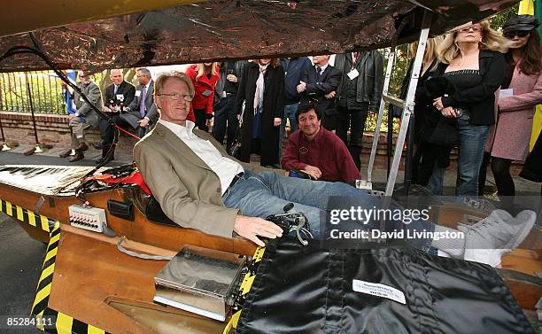 Actor Ed Begely Jr. Poses in the Solar XOF1 car with the vehicle's designer Marcelo da Luz at its unveiling during a reception at the official...