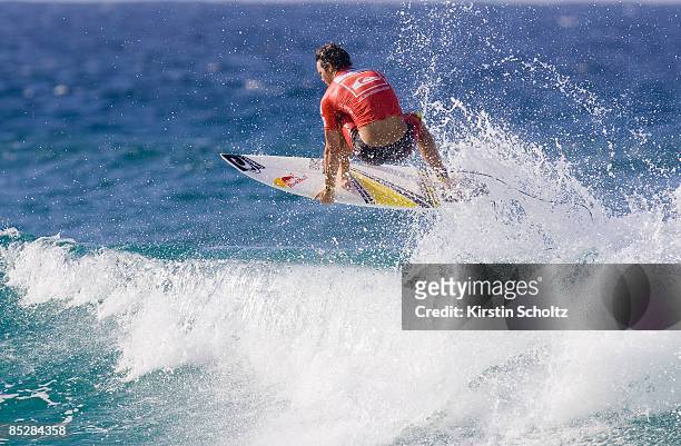 Jordy Smith of South Africa performs an aerial maneuver to win his round two heat against Dean Morrison of Australia during the Quiksilver Pro Gold...
