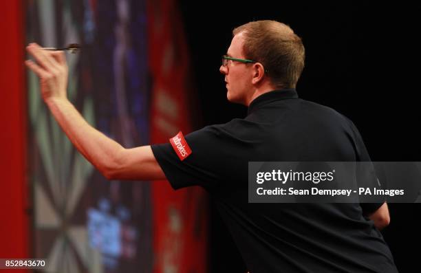 Mark Webster in action against Mensur Suljovic during day seven of The Ladbrokes World Darts Championship at Alexandra Palace, London.