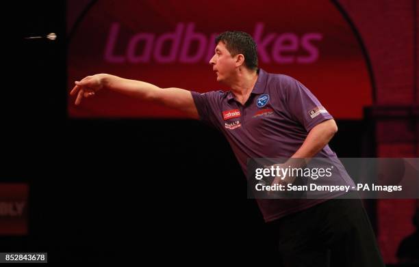 Mensur Suljovic in action against Mark Webster during day seven of The Ladbrokes World Darts Championship at Alexandra Palace, London.