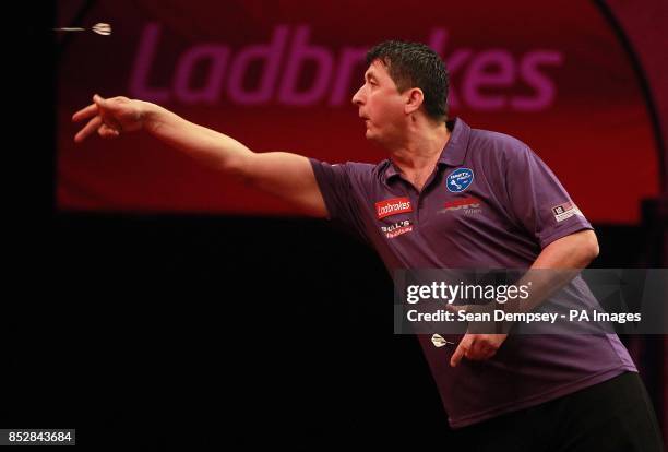 Mensur Suljovic in action against Mark Webster during day seven of The Ladbrokes World Darts Championship at Alexandra Palace, London.