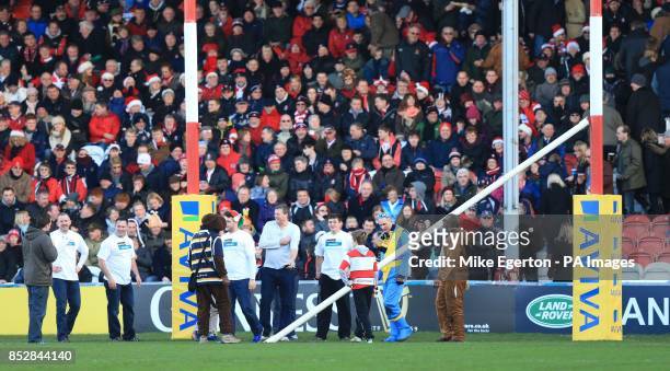 Kick off is delayed after an inflatable rugby ball knocks down the crossbar for the posts before the Aviva Premiership match at the Kingsholm...