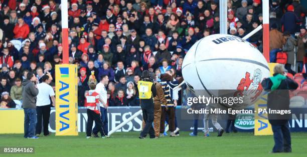 Staff work on the posts after kick off is delayed after an inflatable rugby ball knocks down the crossbar for the posts before the Aviva Premiership...