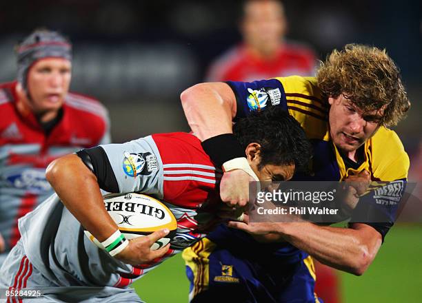 Isaac Ross of the Crusaders is tackled by Adam Thomson of the Highlanders during the round four Super 14 match between the Highlanders and the...