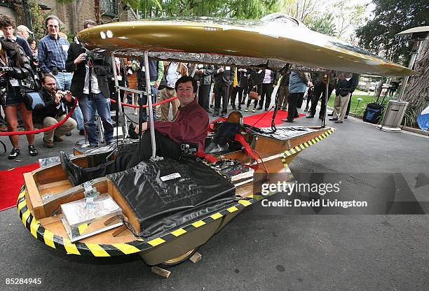 Car designer Marcelo da Luz poses inside his Solar XOF1 vehicle during a reception at the official residence of the Consul General of Canada on March...