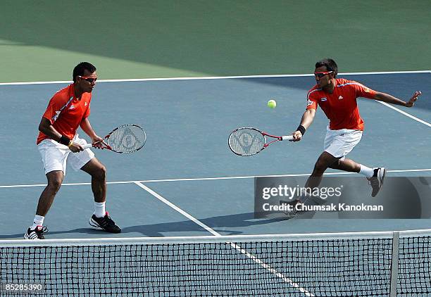 Sanchai Ratiwatana of Thailand return a shot in the doubles match against Carsten Ball and Chris Guccione of Australia during day two of the Davis...