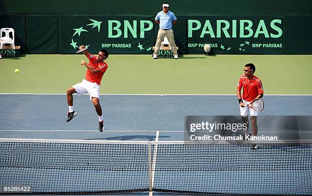 Sonchat Ratiwatana of Thailand returns a shot to Chris Guccione and Carsten Ball of Australia during day two of the Davis Cup Asia/Oceania Group I...