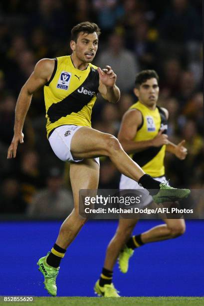 Sam Lloyd of the Tigers kicks the ball during the VFL Grand Final match between Richmond and Port Melbourne at Etihad Stadium on September 24, 2017...