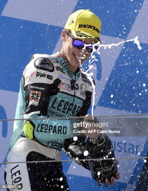 First placed Leopard Racing's rider from Spain, Joan Mir celebrates on the podium after the MOTO 3 race of the Moto Grand Prix of Aragon at the...