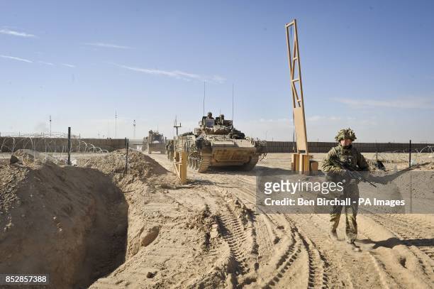 Warrior tracked armoured vehicle exits Patrol Base Lash Durai, Helmand Province, Afghanistan, where British Royal Engineers are fixing a new road...
