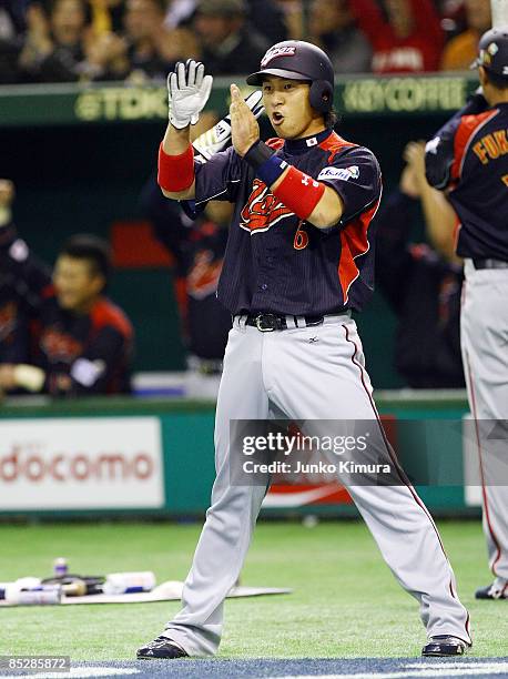 Infielder Hiroyuki Nakajima of Japan celebrates after scoring during the World Baseball Tokyo Round match between Japan and South Korea at Tokyo Dome...