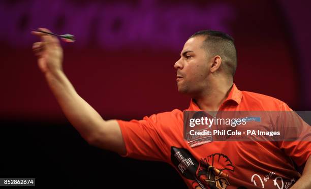 Devon Petersen in action in the first Set against Justin Pipe during day twelve of The Ladbrokes World Darts Championship at Alexandra Palace, London.