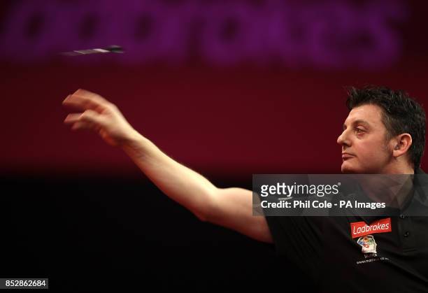 Justin Pipe in action against Devon Petersen during day twelve of The Ladbrokes World Darts Championship at Alexandra Palace, London.