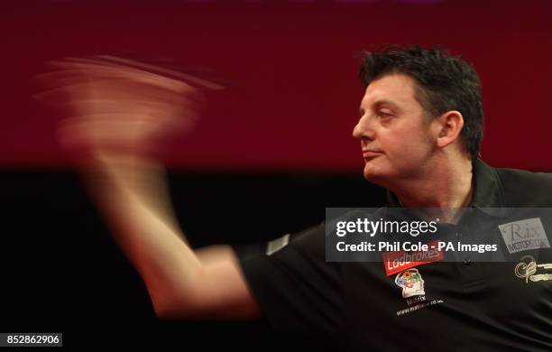 Justin Pipe in action against Devon Petersen during day twelve of The Ladbrokes World Darts Championship at Alexandra Palace, London.