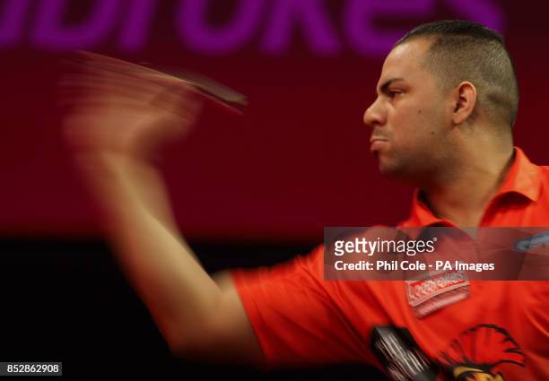 Devon Petersen in action in the first Set against Justin Pipe during day twelve of The Ladbrokes World Darts Championship at Alexandra Palace, London.