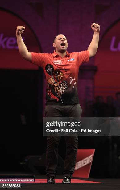 Devon Petersen celebrates winning against Justin Pipe during day twelve of The Ladbrokes World Darts Championship at Alexandra Palace, London.