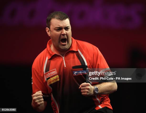 Wes Newton celebrates the first Set against Robert Thornton in the Third round during day twelve of The Ladbrokes World Darts Championship at...