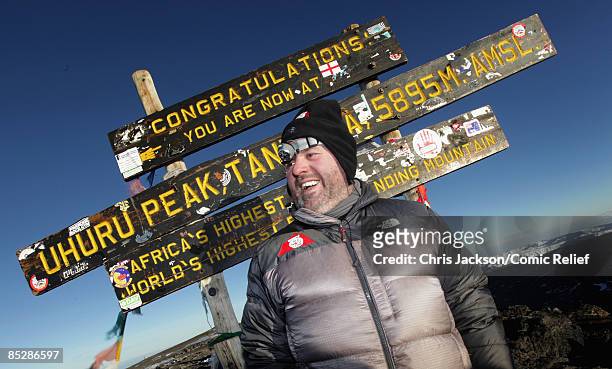 Radio One DJ Chris Moyles laughs as he reaches the top of Mount Kilimanjaro on the seventh day of The BT Red Nose Climb of Kilimanjaro on March 7,...