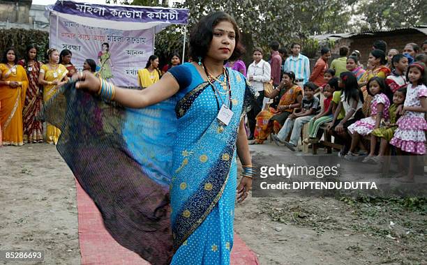 An Indian sex worker walks along a makeshift catwalk during a fashion show organised at the Khalpara red light area in Siliguri on March 7, 2009 on...