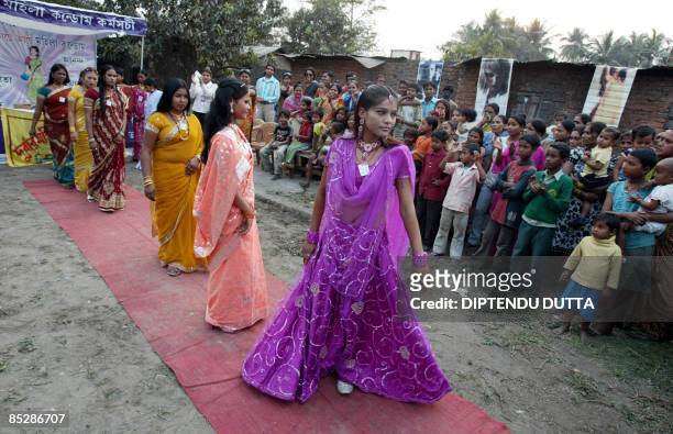 Indian sex workers walk along a makeshift catwalk during a fashion show organised at the Khalpara red light area in Siliguri on March 7, 2009 on the...