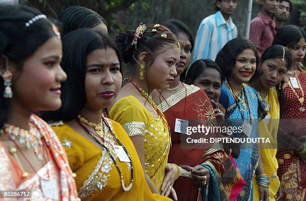 Indian sex workers await their turn to walk along a makeshift catwalk during a fashion show organised at the Khalpara red light area in Siliguri on...