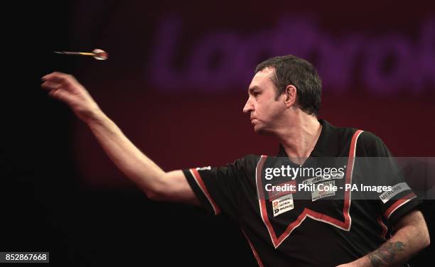 Richie Burnett in action against Ian White in the Third round,during day twelve of The Ladbrokes World Darts Championship at Alexandra Palace, London.