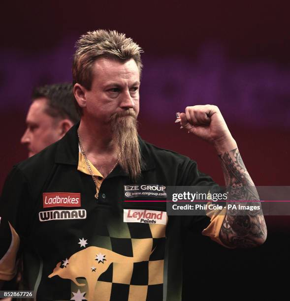 Simon Whitlock celebrates winning against Kevin Painter during the third round match,during day twelve of The Ladbrokes World Darts Championship at...