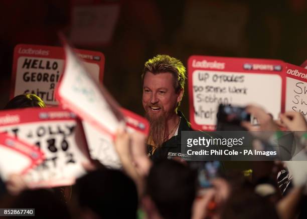 Simon Whitlock walks out to play against Kevin Painter during the third round match,during day twelve of The Ladbrokes World Darts Championship at...