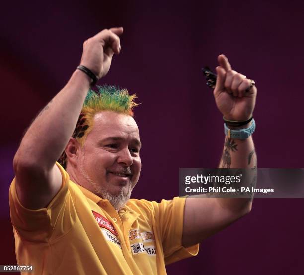 Peter Wright celebrates winning against Michael Smith during the third round match,during day twelve of The Ladbrokes World Darts Championship at...