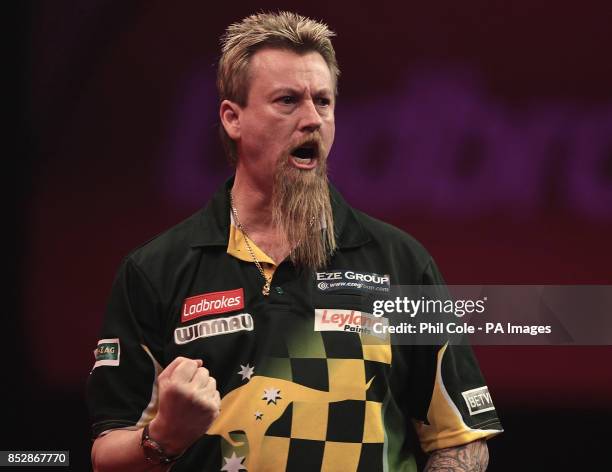 Simon Whitlock celebrates taking the first Set against Kevin Painter during the third round match,during day twelve of The Ladbrokes World Darts...