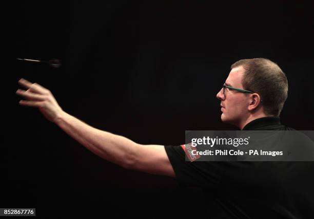 Mark Webster in action against Raymond van Barneveld during the third round match,during day twelve of The Ladbrokes World Darts Championship at...