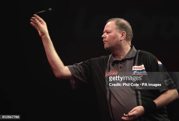 Raymond van Barneveld in action against Mark Webster during the third round match,during day twelve of The Ladbrokes World Darts Championship at...
