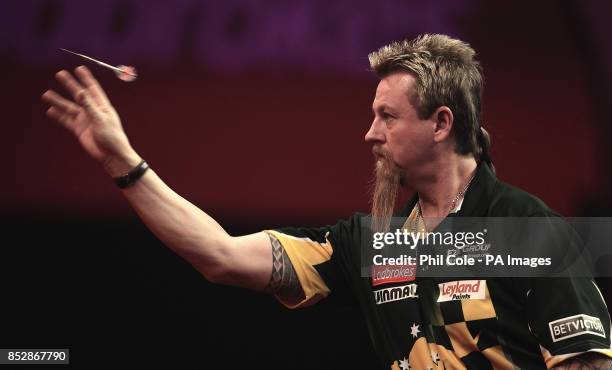 Simon Whitlock in action against Kevin Painter during the third round matchduring day twelve of The Ladbrokes World Darts Championship at Alexandra...